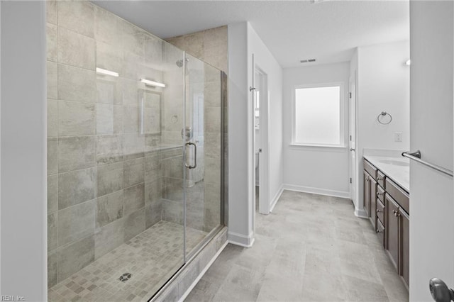 bathroom with vanity and a shower with shower door