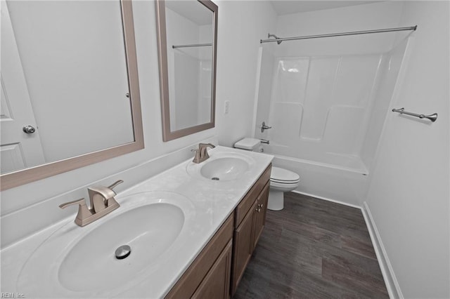 full bathroom with vanity, hardwood / wood-style flooring, shower / washtub combination, and toilet