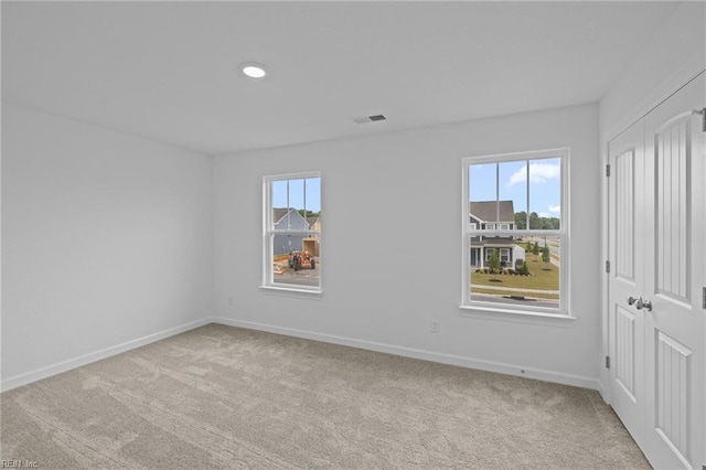 carpeted spare room with a wealth of natural light