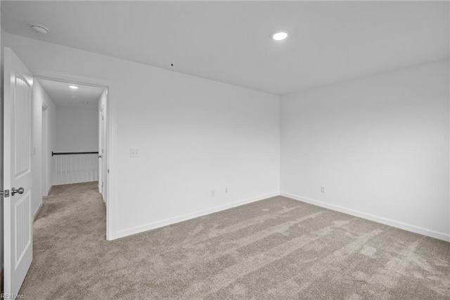 spare room featuring light colored carpet