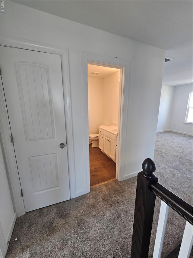307 Iris Cir, Moyock, NC 27958 - corridor with dark carpet and baseboards