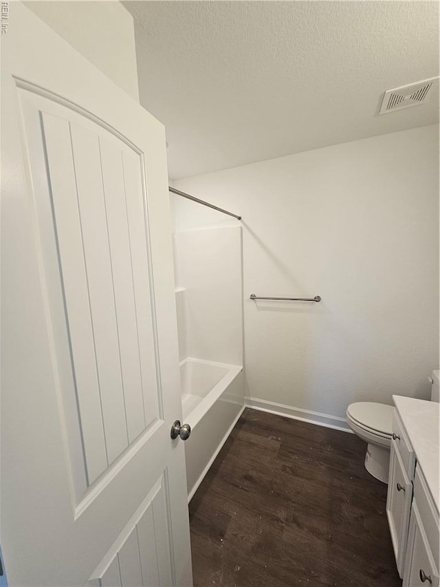 307 Iris Cir, Moyock, NC 27958 - bathroom with wood finished floors, baseboards, vanity, a textured ceiling, and toilet