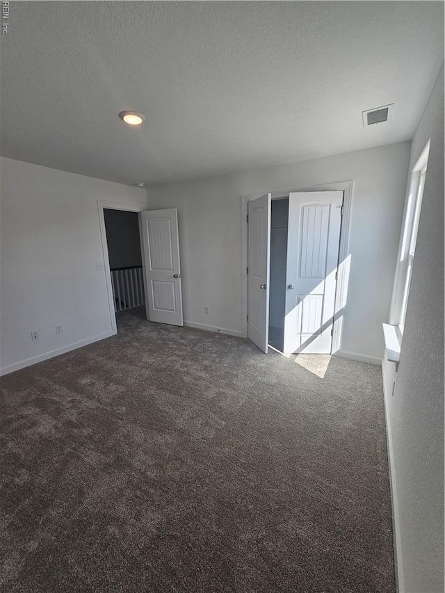 307 Iris Cir, Moyock, NC 27958 - carpeted spare room featuring baseboards, a textured ceiling, and recessed lighting