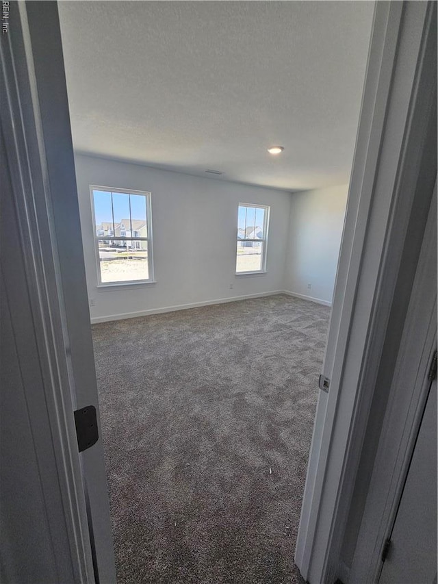 307 Iris Cir, Moyock, NC 27958 - unfurnished room featuring carpet, baseboards, and a textured ceiling
