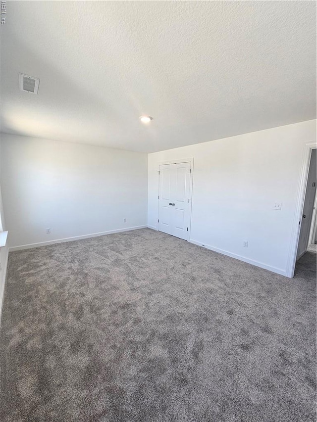 307 Iris Cir, Moyock, NC 27958 - spare room featuring carpet floors, baseboards, and a textured ceiling