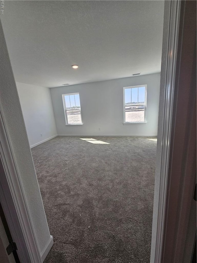 307 Iris Cir, Moyock, NC 27958 - carpeted spare room featuring plenty of natural light, baseboards, and recessed lighting