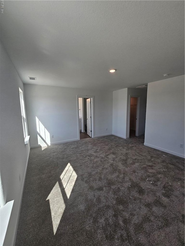 307 Iris Cir, Moyock, NC 27958 - carpeted empty room with baseboards and a textured ceiling