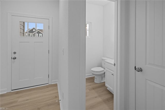 bathroom with wood-type flooring, vanity, and toilet