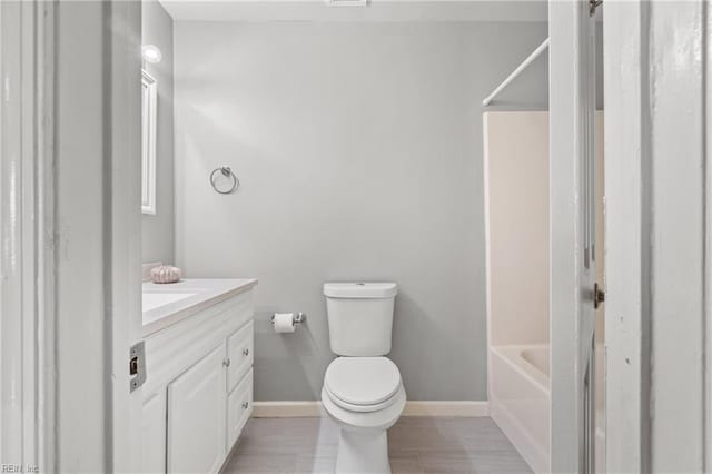 full bathroom featuring bathtub / shower combination, vanity, and toilet