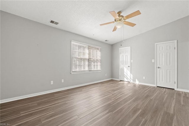 empty room featuring ceiling fan, lofted ceiling, and hardwood / wood-style floors