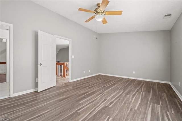 unfurnished bedroom featuring dark wood-type flooring, ceiling fan, and vaulted ceiling