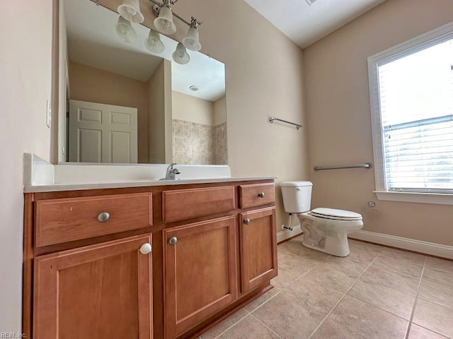 bathroom featuring toilet, tile patterned floors, and vanity