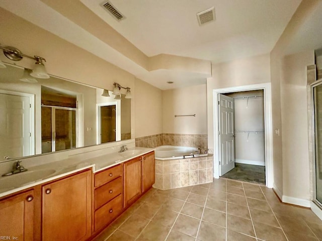 bathroom with shower with separate bathtub, vanity, and tile patterned flooring