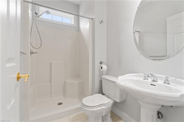 bathroom with sink, toilet, tile patterned flooring, and walk in shower