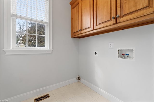 laundry room with washer hookup, electric dryer hookup, light tile patterned floors, and cabinets