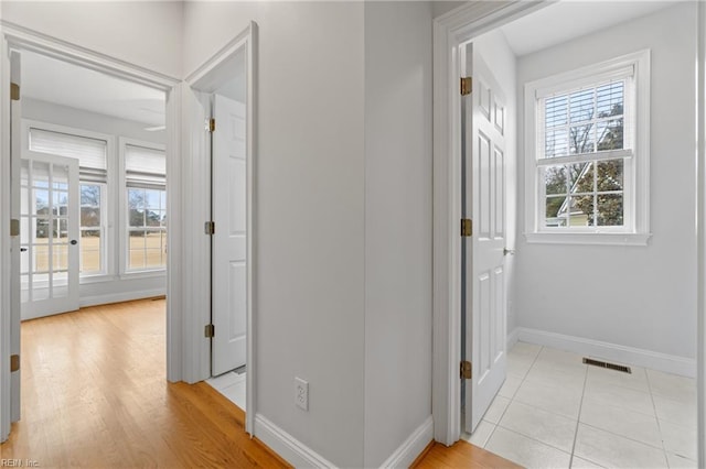 hall featuring light tile patterned floors