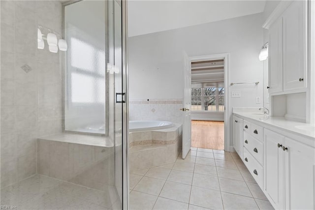 bathroom featuring separate shower and tub, tile patterned flooring, and vanity