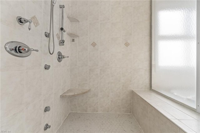 bathroom featuring a tile shower