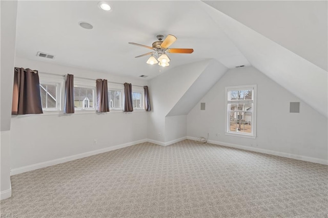 additional living space featuring vaulted ceiling, ceiling fan, and light colored carpet