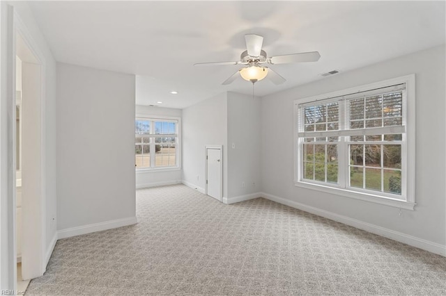 unfurnished room featuring ceiling fan and light carpet