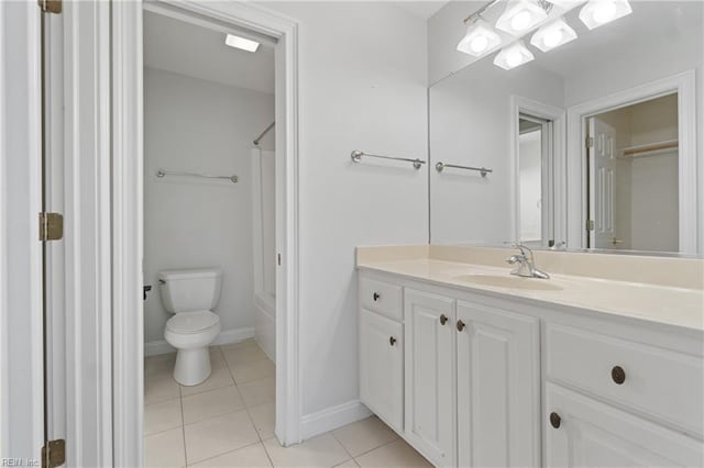 bathroom featuring toilet, tile patterned floors, and vanity