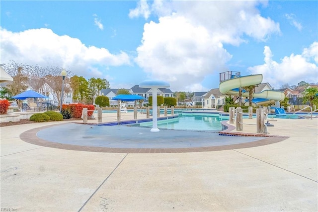 view of pool featuring a patio and a water slide