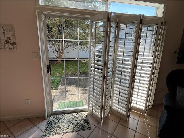 doorway with light tile patterned floors