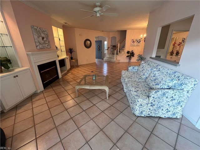 living room featuring light tile patterned floors and ceiling fan