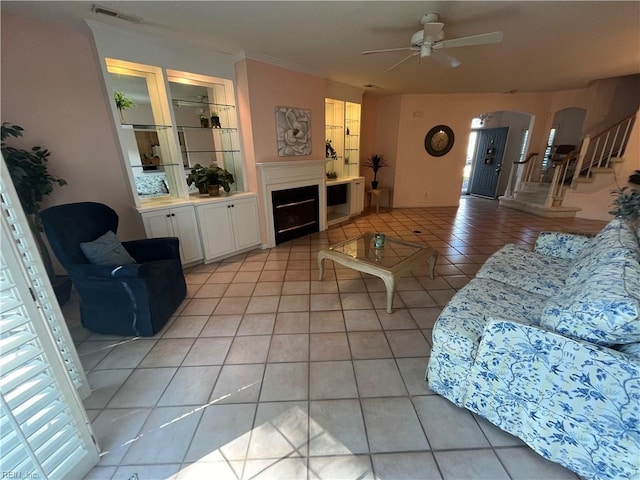 tiled living room with ceiling fan