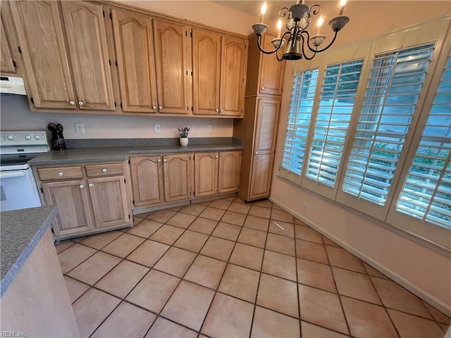 kitchen with decorative light fixtures, white electric range oven, an inviting chandelier, and light tile patterned floors