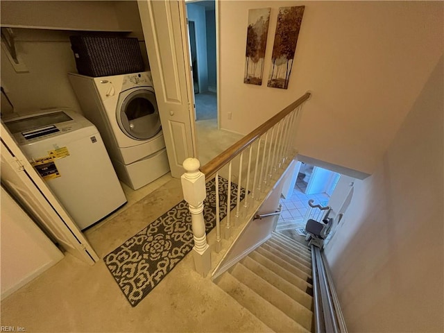 clothes washing area with washer and clothes dryer