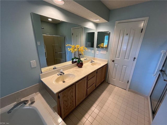 bathroom featuring tile patterned flooring, shower with separate bathtub, and vanity