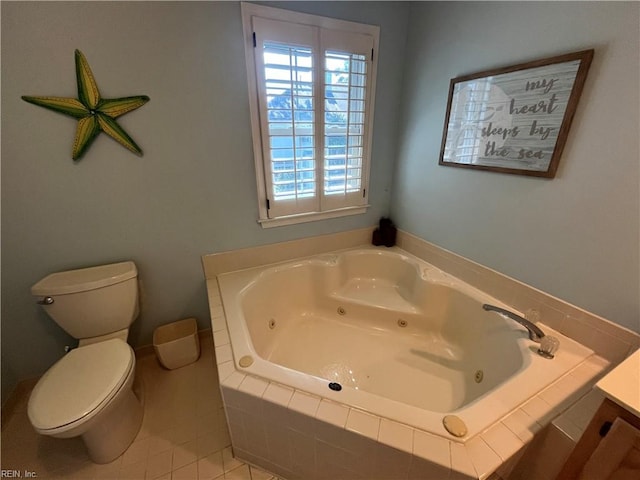 bathroom featuring toilet, tile patterned floors, tiled bath, and vanity