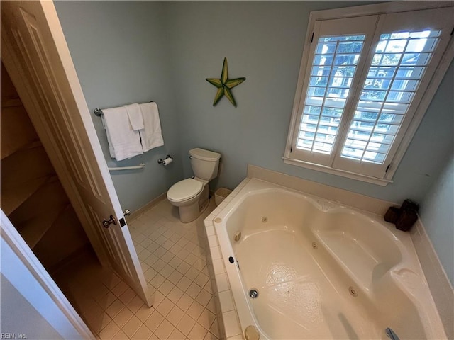 bathroom with tile patterned floors, toilet, and a bathing tub