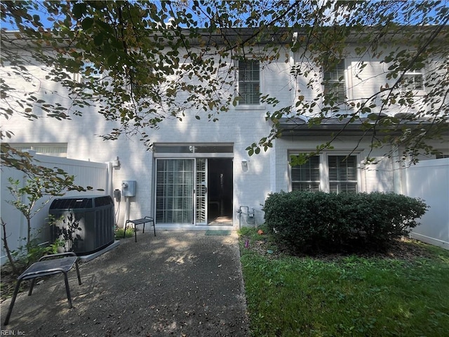 rear view of property featuring central AC and a patio