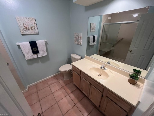 bathroom featuring a shower with door, vanity, tile patterned floors, and toilet