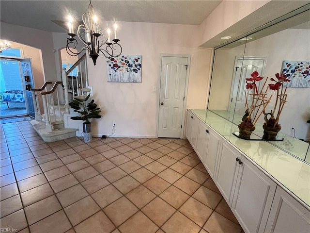 interior space with light tile patterned floors and a chandelier