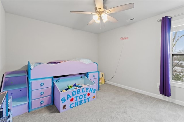 bedroom featuring light colored carpet and ceiling fan