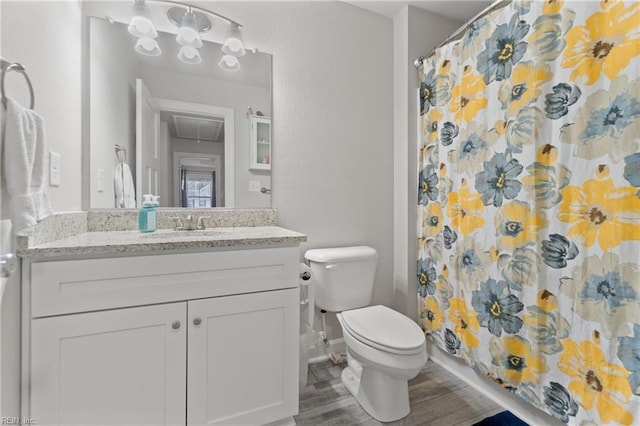 bathroom with vanity, curtained shower, wood-type flooring, and toilet