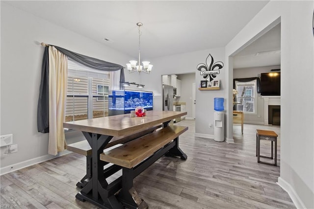 dining area with a chandelier and light wood-type flooring