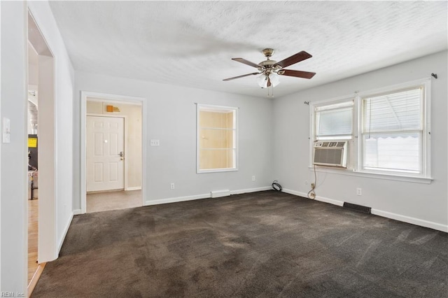 carpeted empty room featuring ceiling fan, cooling unit, and a textured ceiling