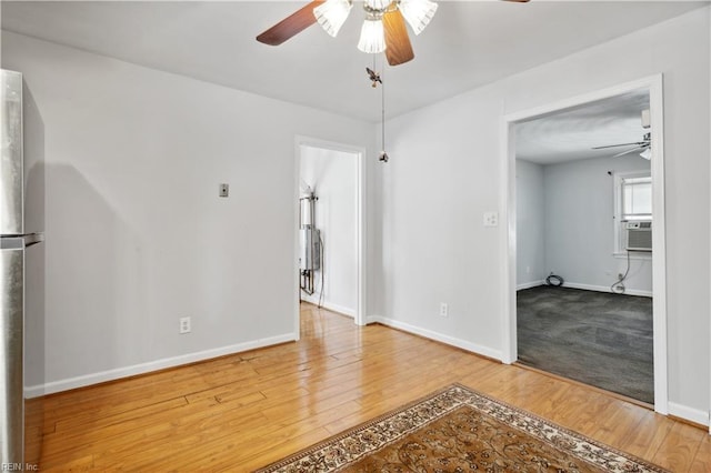 spare room featuring wood-type flooring and ceiling fan