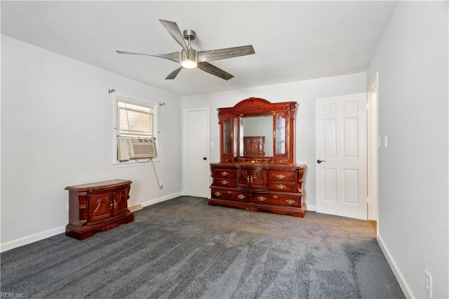 unfurnished bedroom featuring dark carpet, cooling unit, and ceiling fan