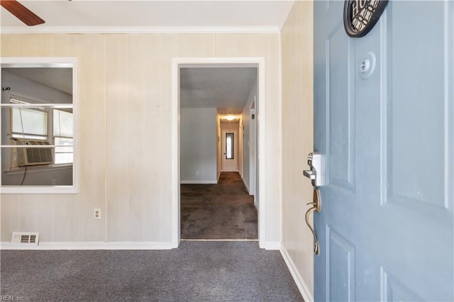 carpeted entryway featuring cooling unit, ceiling fan, and ornamental molding