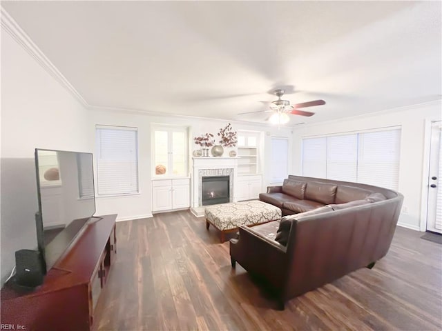 living room featuring crown molding, dark hardwood / wood-style floors, built in features, and ceiling fan