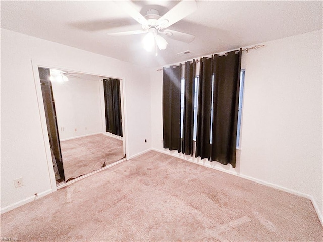 spare room with carpet flooring and ceiling fan