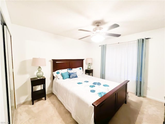 carpeted bedroom featuring ceiling fan and a closet