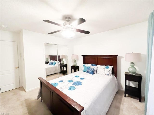 carpeted bedroom featuring ceiling fan and a closet