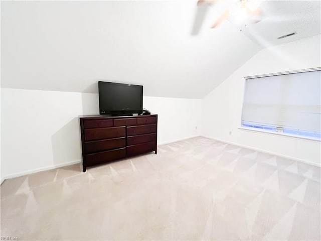 additional living space featuring ceiling fan, lofted ceiling, and light carpet