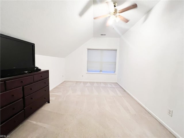 additional living space featuring lofted ceiling, light carpet, and ceiling fan